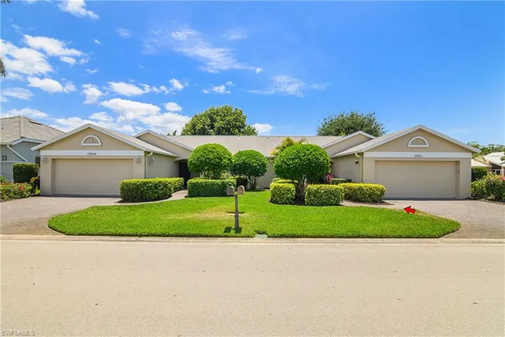 Ranch-style home featuring an attached garage, stucco siding, decorative driveway, and a front yard