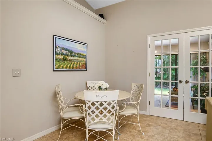 Dining room featuring french doors and baseboards