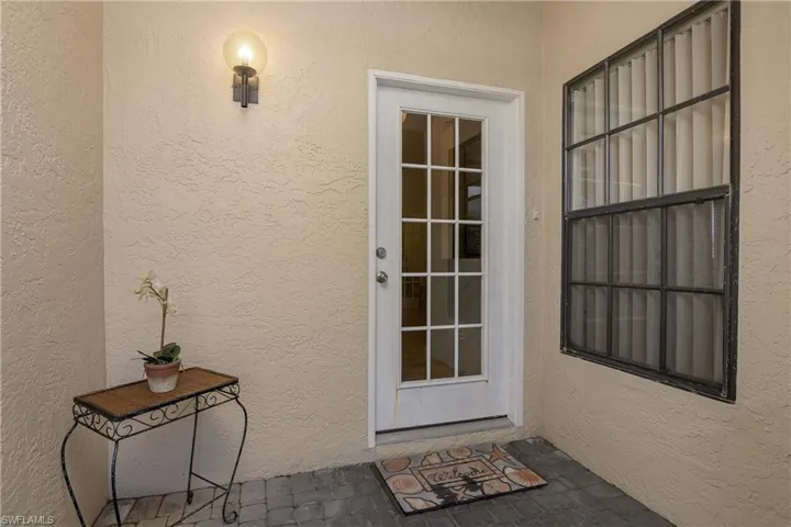 Entrance to property with stucco siding