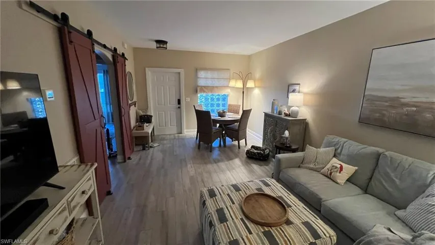 Living room with hardwood / wood-style flooring and a barn door