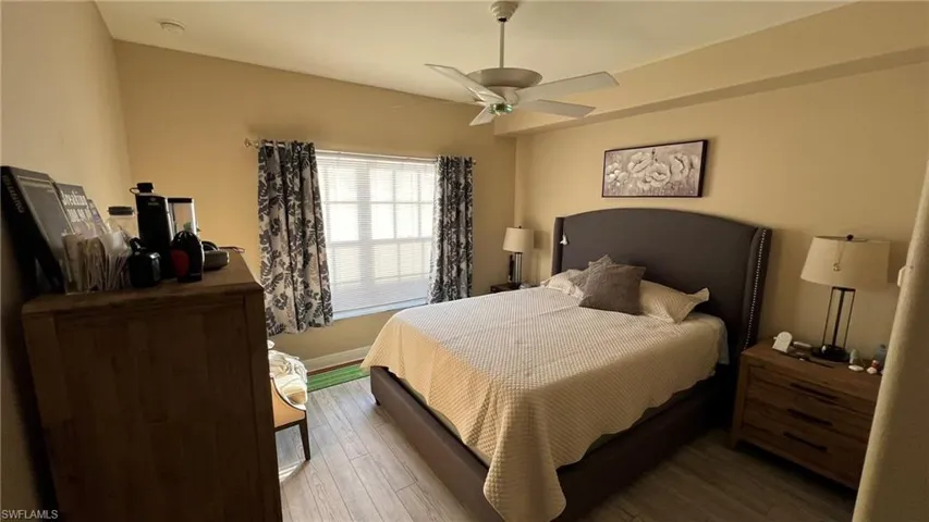 Bedroom with ceiling fan and dark hardwood / wood-style flooring