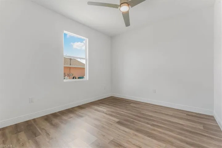 Empty room with light wood-type flooring and ceiling fan