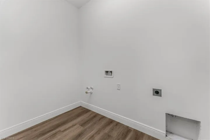 Washroom with electric dryer hookup, washer hookup, wood finished floors, and hookup for a gas dryer