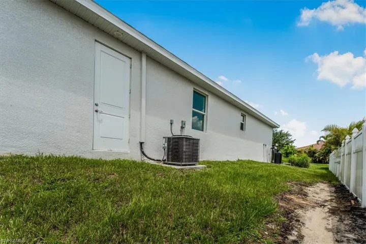 View of side of home featuring stucco siding