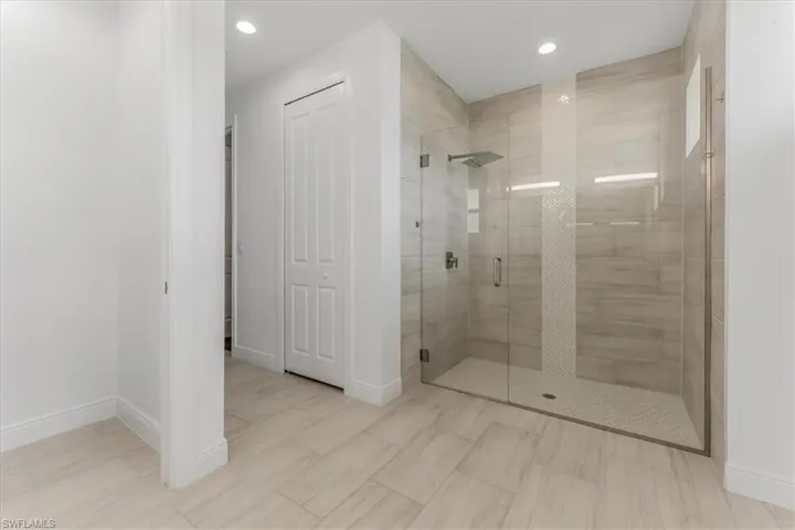 Bathroom with a shower stall and recessed lighting