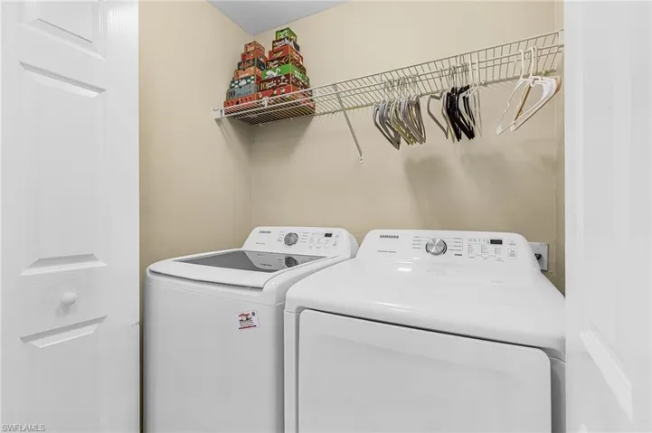 Laundry area featuring a top-load washing machine and front-load dryer