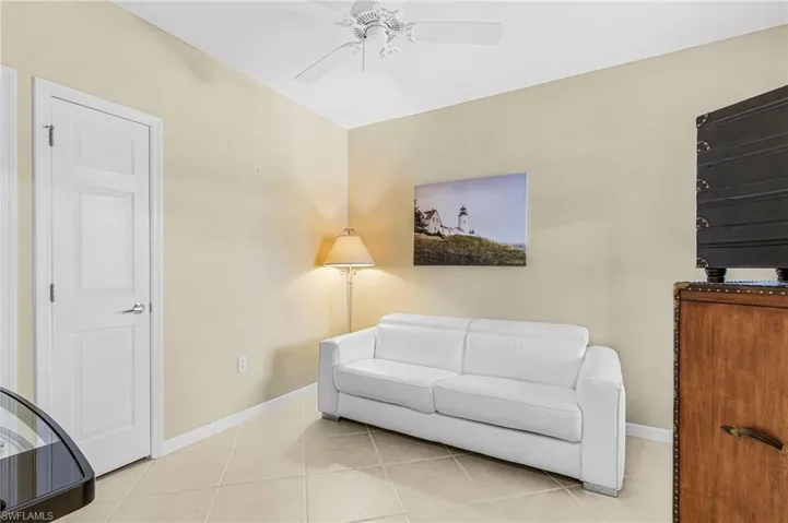 Recessed ceiling, neutral wall tones, and tiled flooring create a versatile interior space