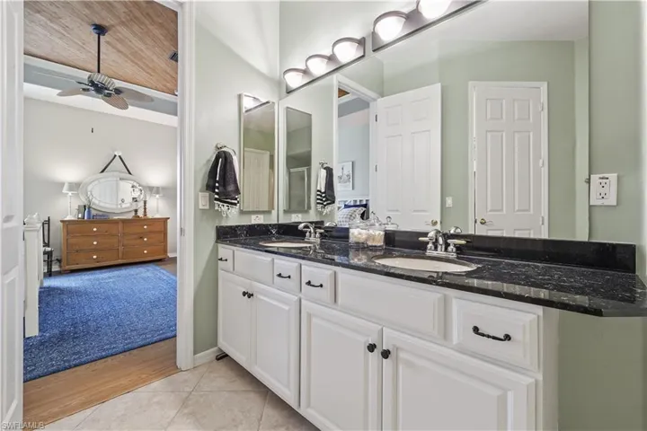 Bathroom with tile patterned flooring, vanity, and ceiling fan