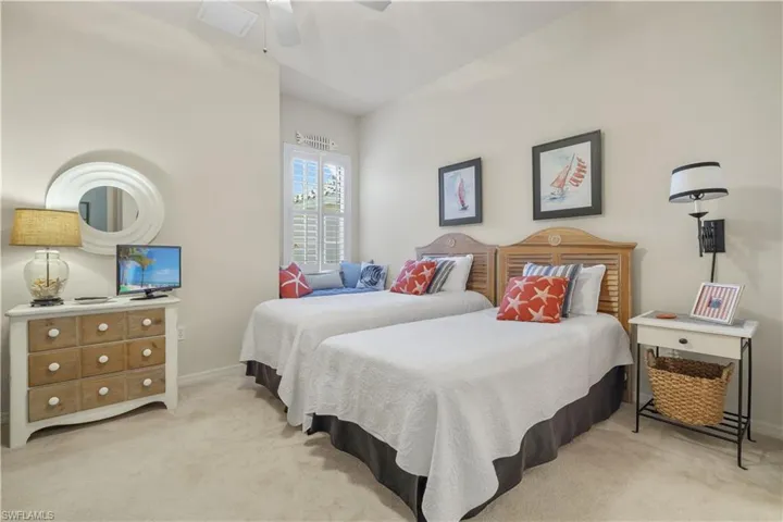 Carpeted bedroom featuring ceiling fan