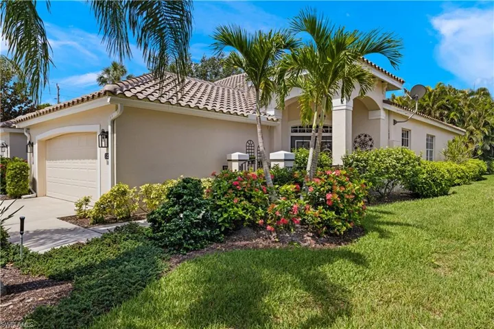 View of front of house featuring a front yard and a garage