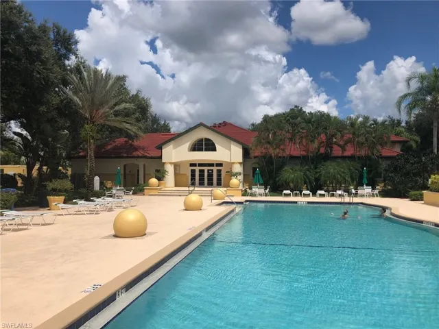 Community pool with a patio and french doors