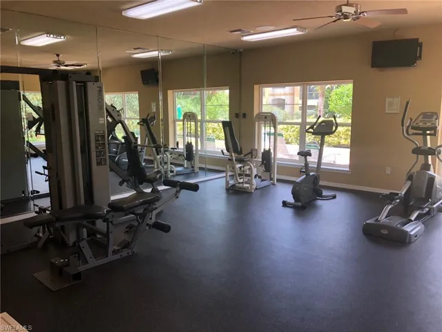 Workout area featuring baseboards and ceiling fan
