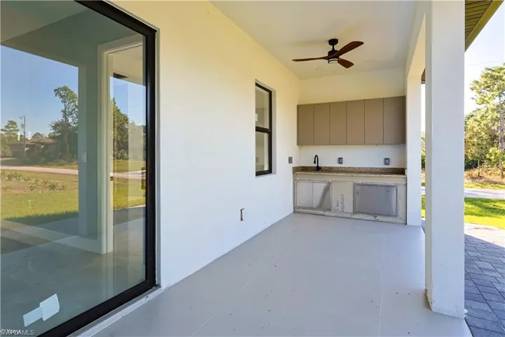 View of patio / terrace with area for grilling and a ceiling fan