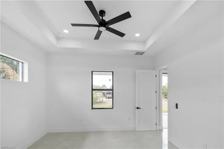 Recessed tray ceiling with a contemporary black ceiling fan and integrated lighting