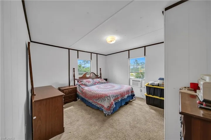 Bedroom featuring multiple windows and carpet