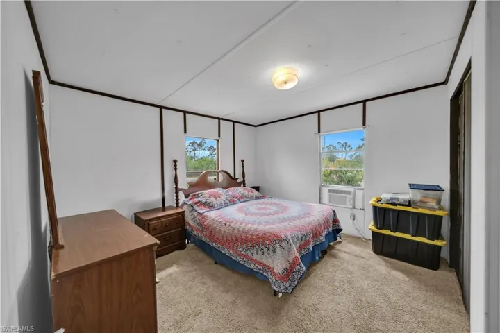 Bedroom featuring carpet floors and multiple windows