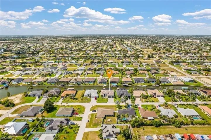 Aerial perspective showcasing a residential area with canal access