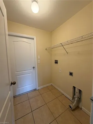 Tiled flooring, wire shelving, and overhead lighting