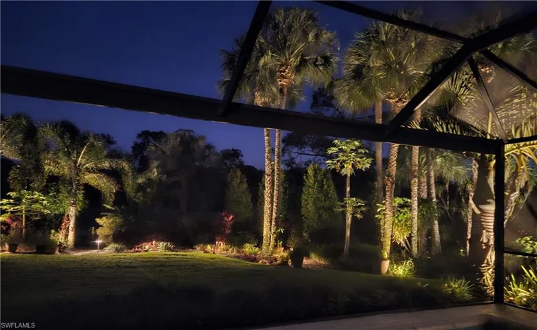 Yard at twilight featuring a lawn