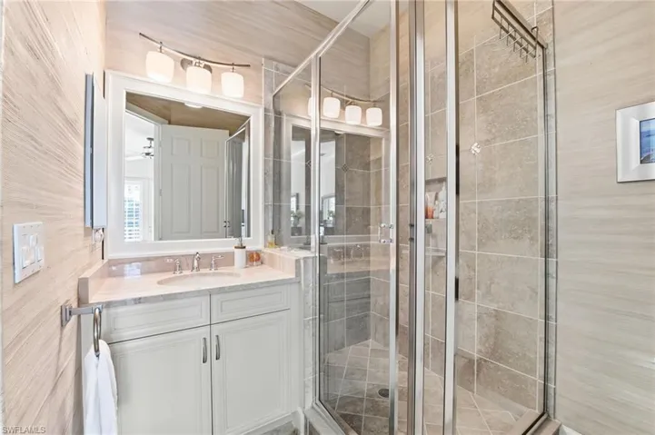 Bathroom featuring vanity and a stall shower