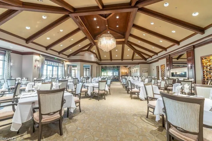 Dining room with hanging lights and crown molding