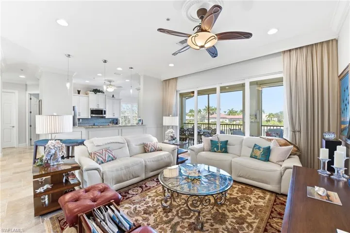 Living area featuring ornamental molding, ceiling fan, and recessed lighting