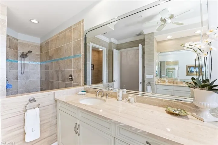 Full bath with vanity, a walk in shower, a ceiling fan, and recessed lighting