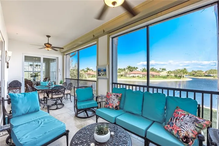 Sunroom featuring ceiling fan, a water view, and an outdoor living / dining area