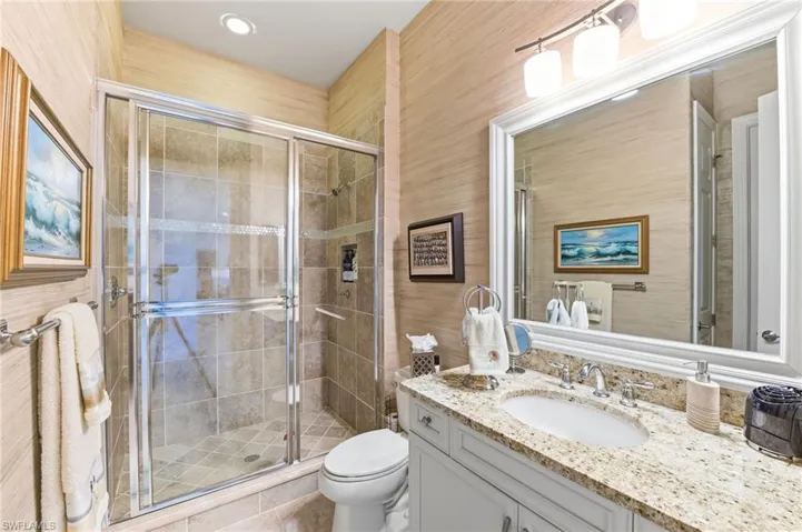 Bathroom with vanity and a shower stall