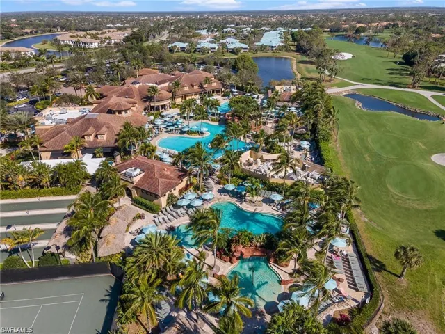 Aerial view of property and surrounding area with a large body of water and a golf course