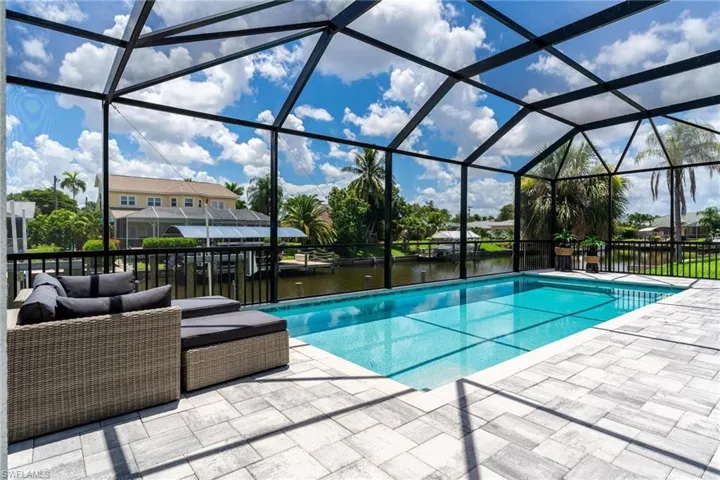 View of swimming pool featuring an outdoor hangout area, glass enclosure, and a patio area