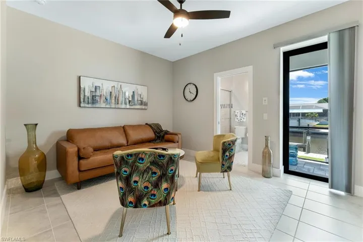 Spare room with wine bar light tile patterned floors and ceiling fan