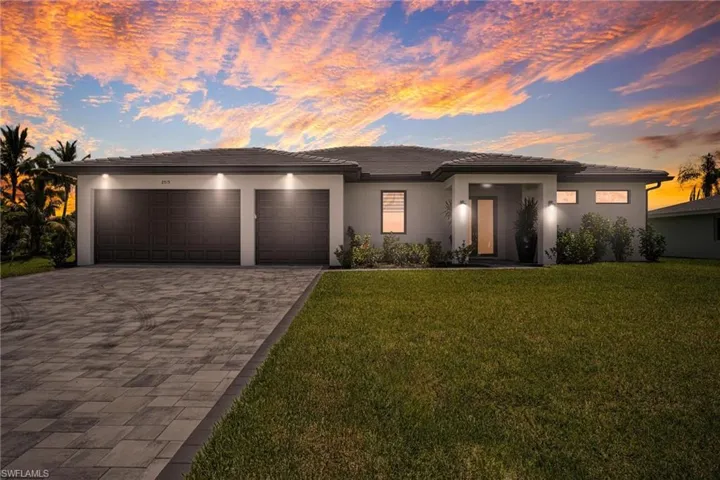 Prairie-style home with a garage and a yard