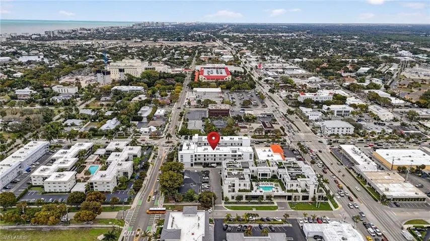 Aerial view of property and surrounding area with nearby urban area