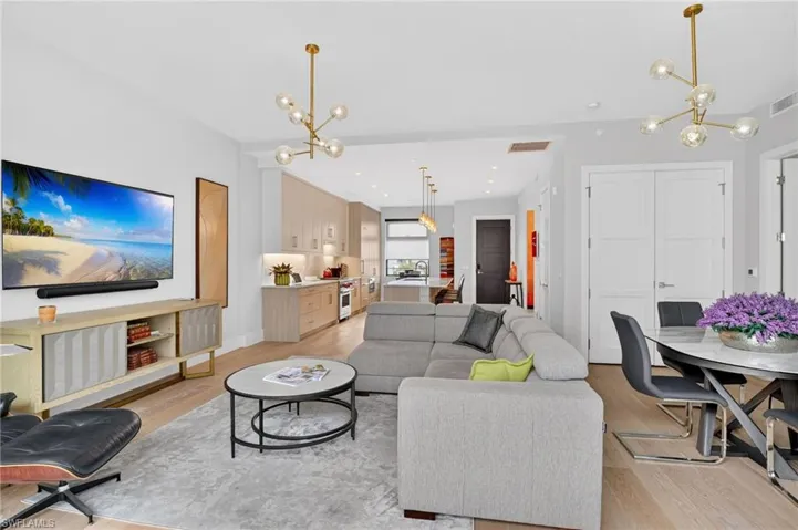 Living area with a chandelier and light wood-style floors