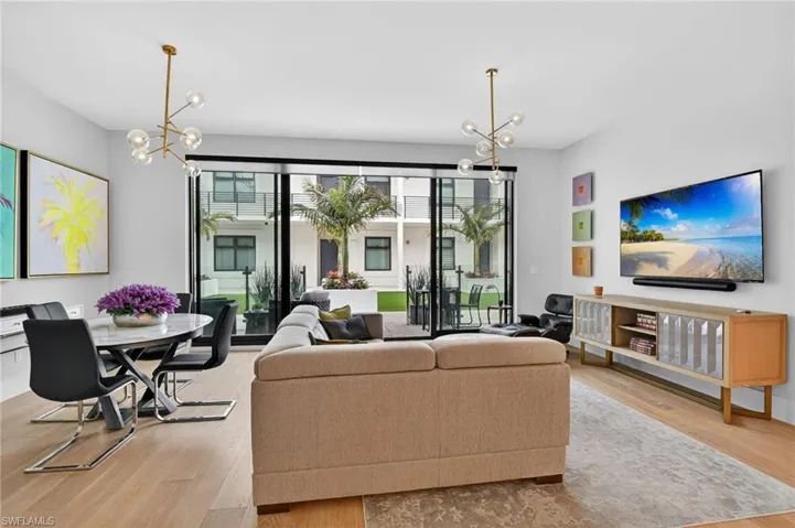 Living area with a chandelier and light wood finished floors