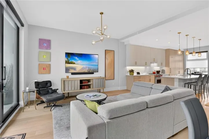 Living area featuring a chandelier and light wood-type flooring