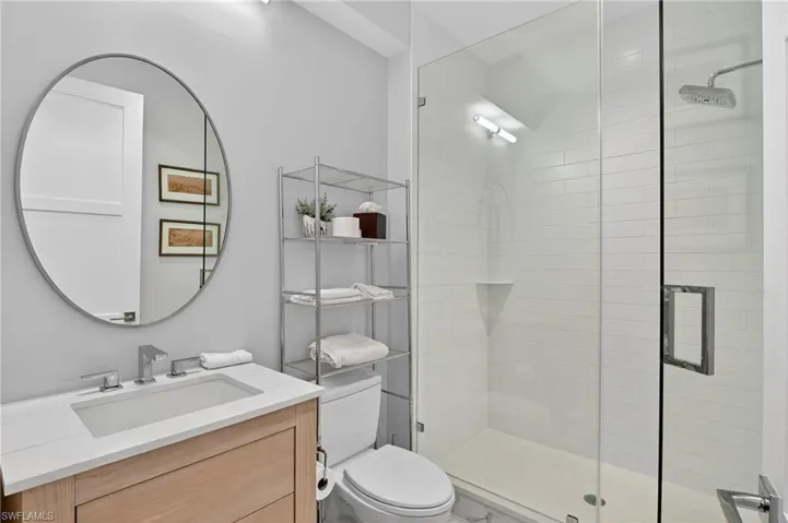 Bathroom featuring a shower stall and vanity