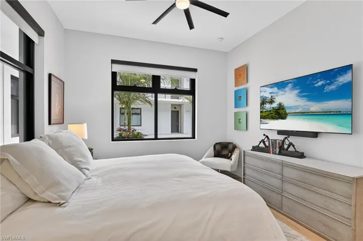 Bedroom with ceiling fan and light wood-type flooring