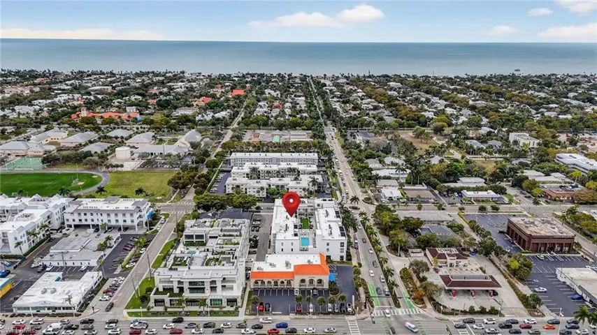 Aerial view of property and surrounding area with a nearby body of water