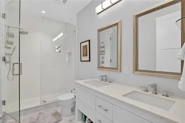 Bathroom with a shower stall and double vanity