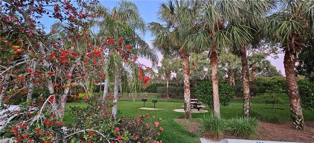 Barbecue area across from property with beautiful landscapes