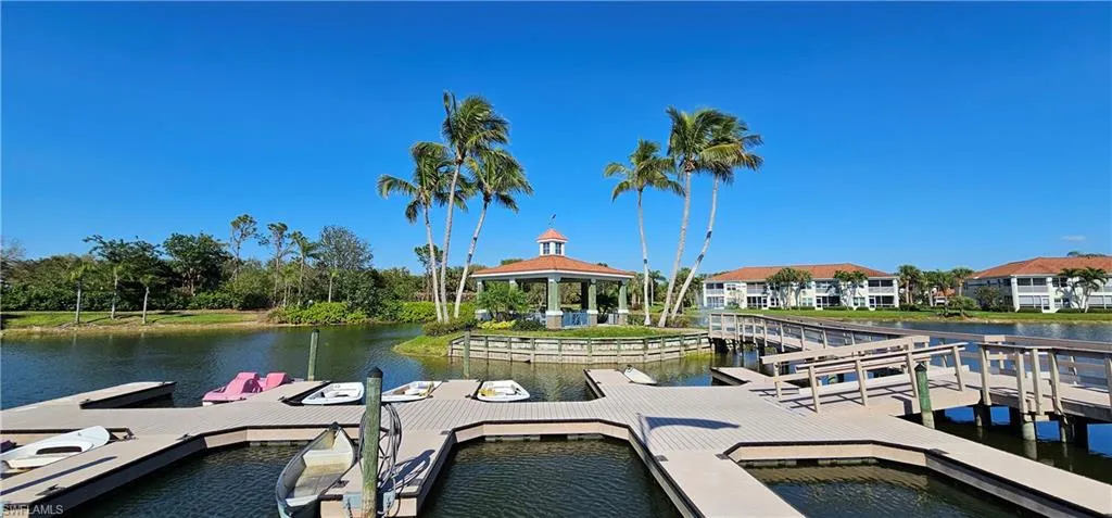 Boathouse area with docks and featuring a gazebo and a water view