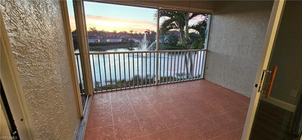 Spacious balcony at dusk with a water view