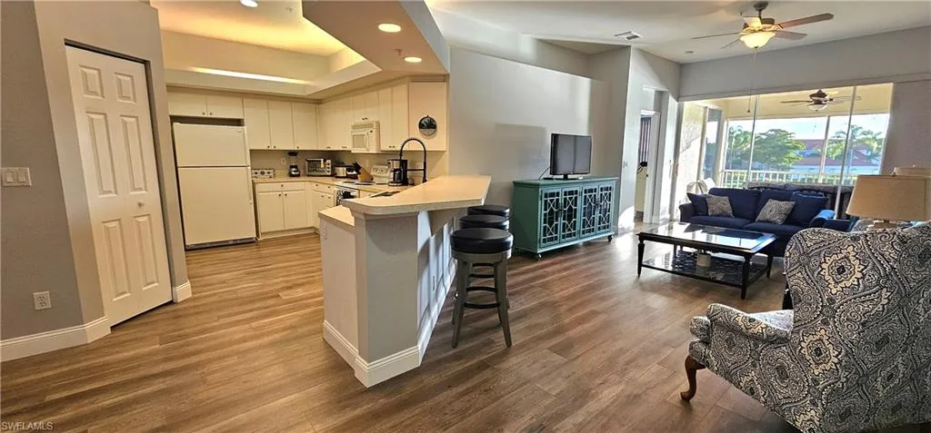 Kitchen featuring light countertops and white cabinetry