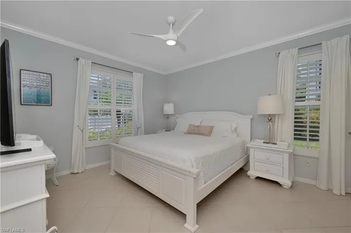 Bedroom featuring Ornamental Molding, Multiple Windows, and Ceiling Fan