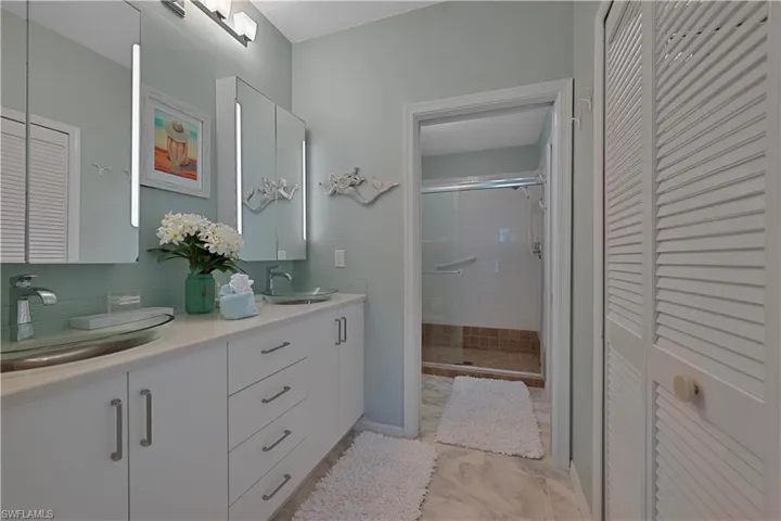 Full Bathroom with  Closet, Double Vanity, and Stall Shower