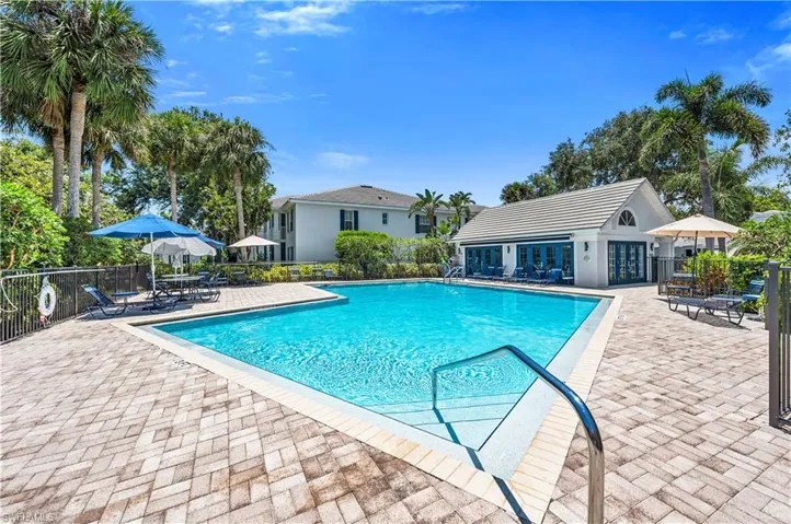 Community Pool featuring a brick paver patio and clubhouse