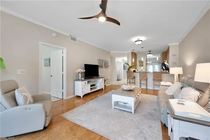 Living Room featuring Crown Molding, Ceiling Fan