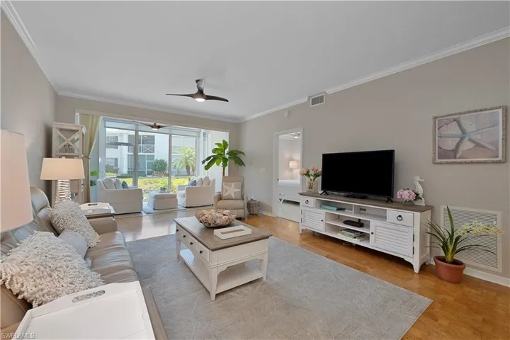 Living Room with Crown Molding and Ceiling Fan
